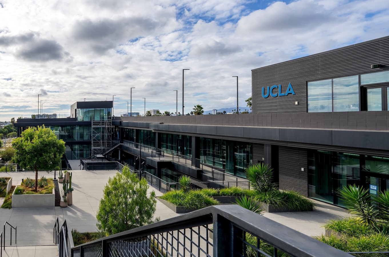 Exterior of the shopping mall with bushes, envisioned with UCLA logos on it