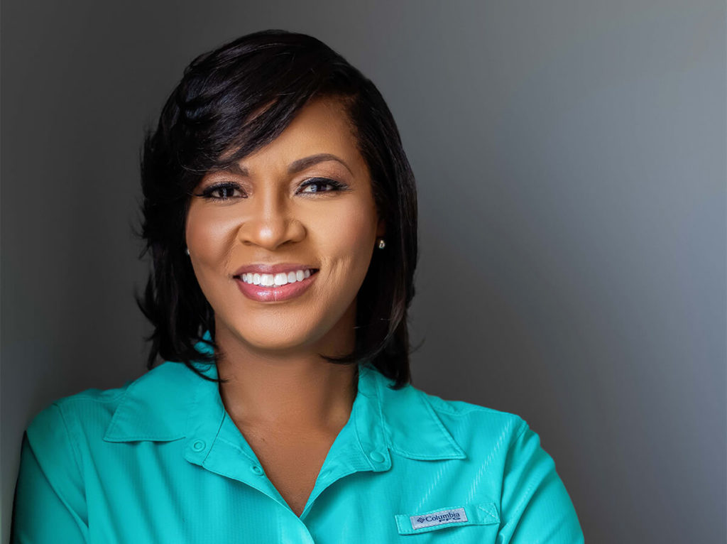 Alexandra Jones, Black woman in bob and teal blouse, smiling