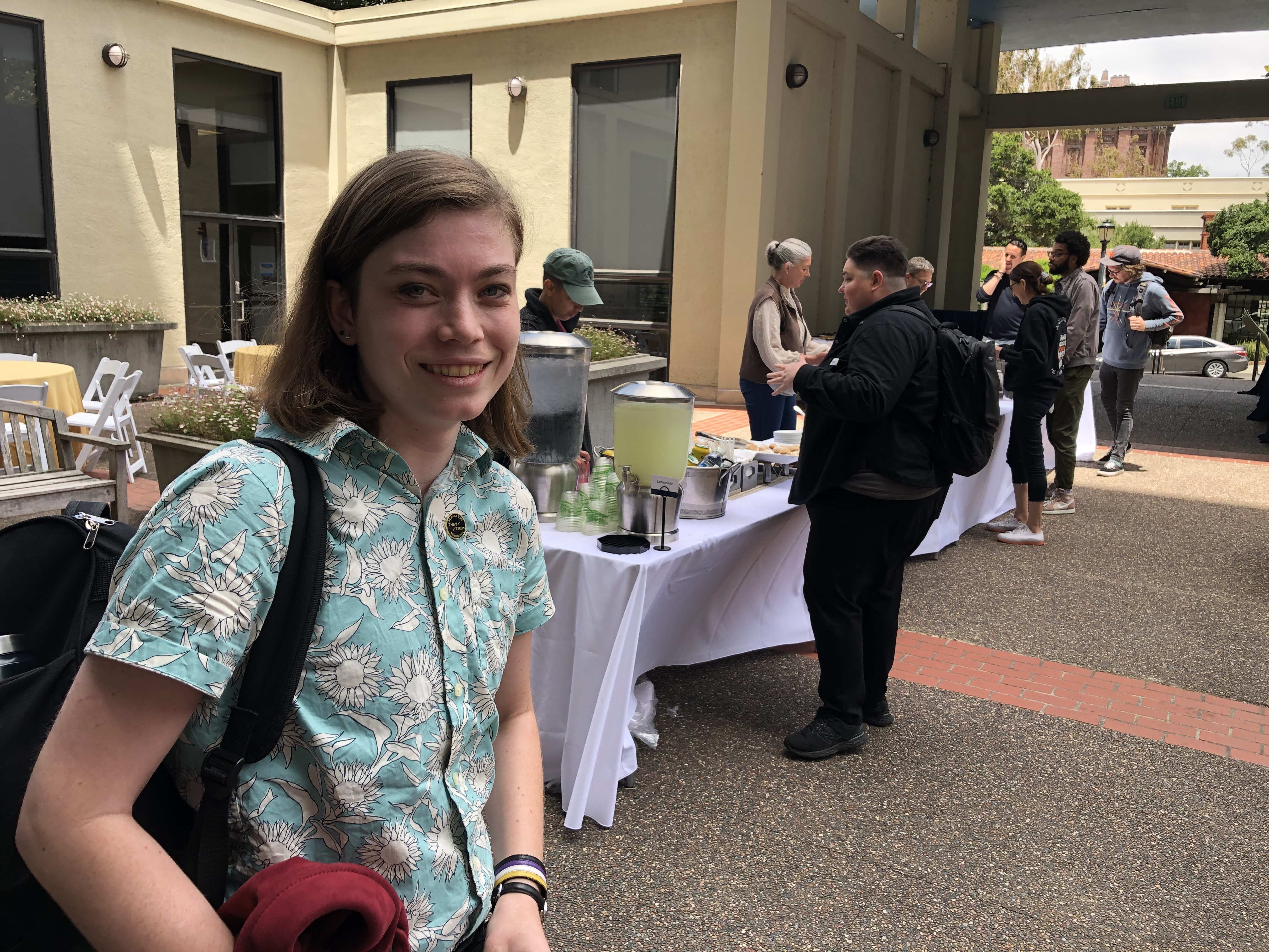 Young teacher, Bridgit Lee, smiles at a registration table in Berkeley