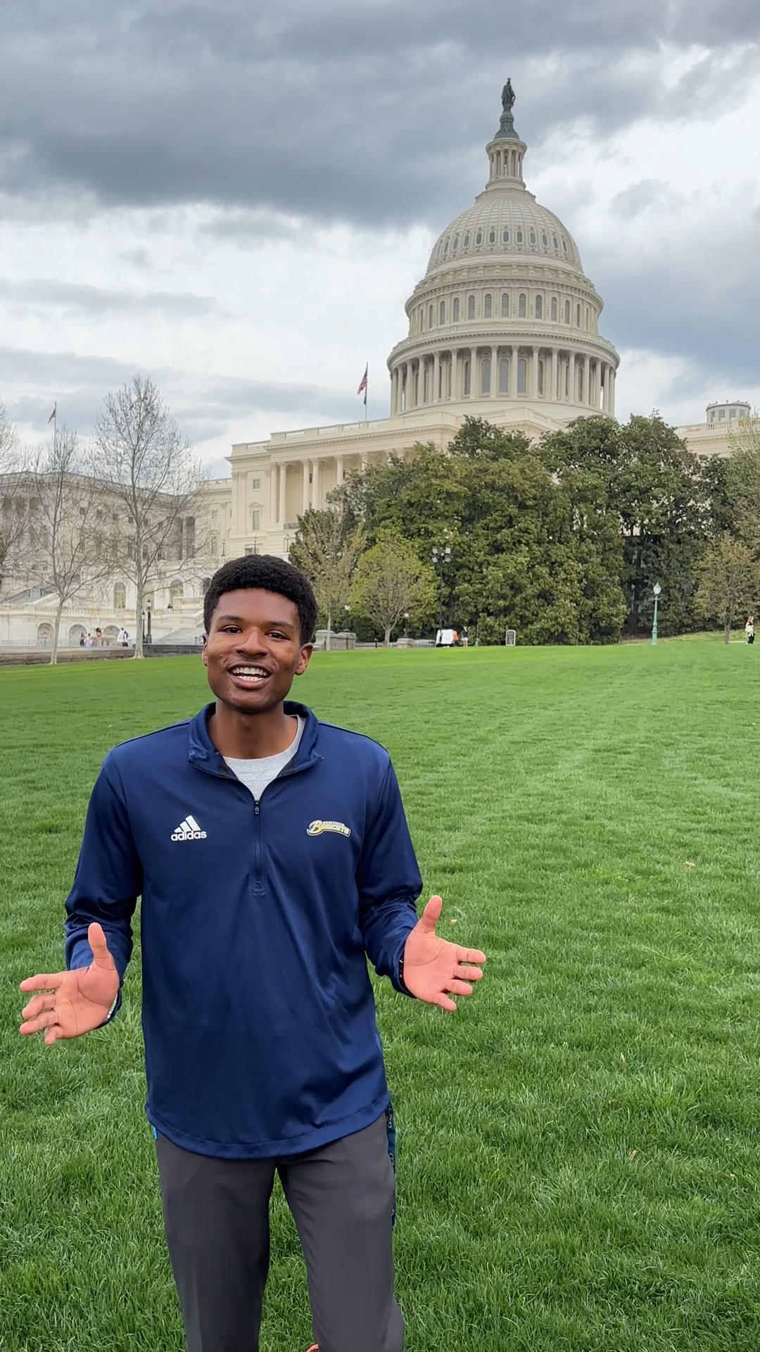 AJ Heard speaks in front of US Capitol Building on a green lawn, gesticulating with his hands