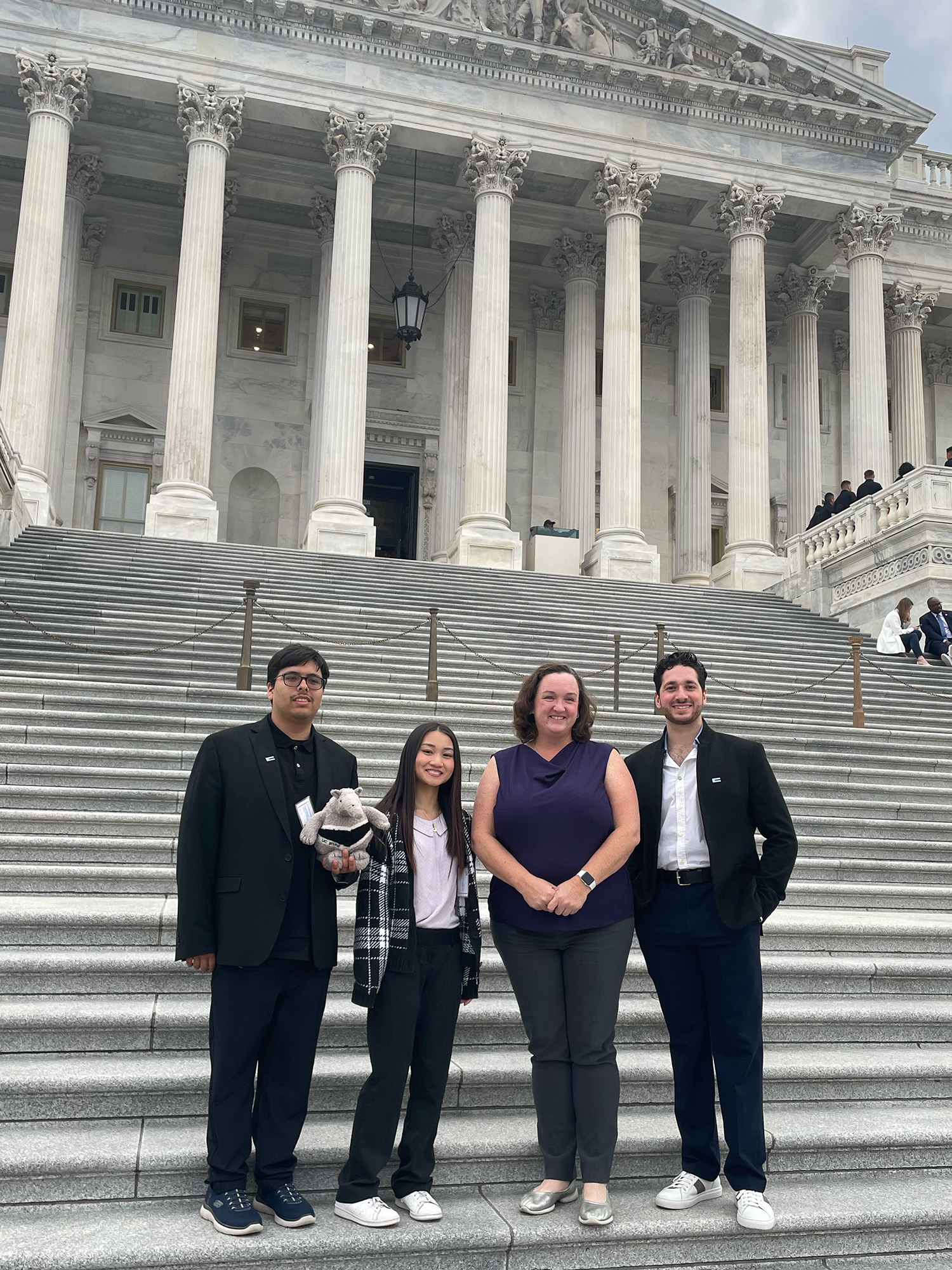 UC students pose on the steps of the Supreme Court building with CA Rep Katie Porter