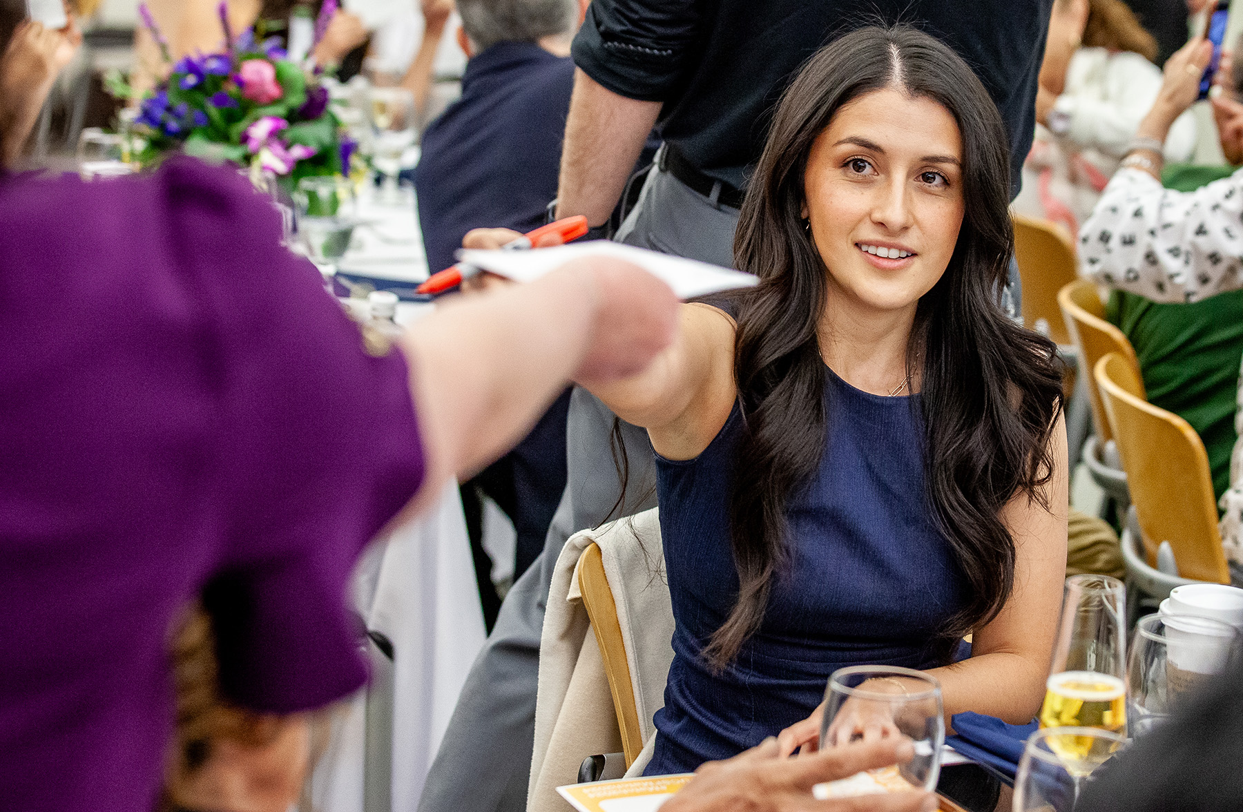 Vanessa Mora Molina accepts a fist bump from a person who's face is not on screen