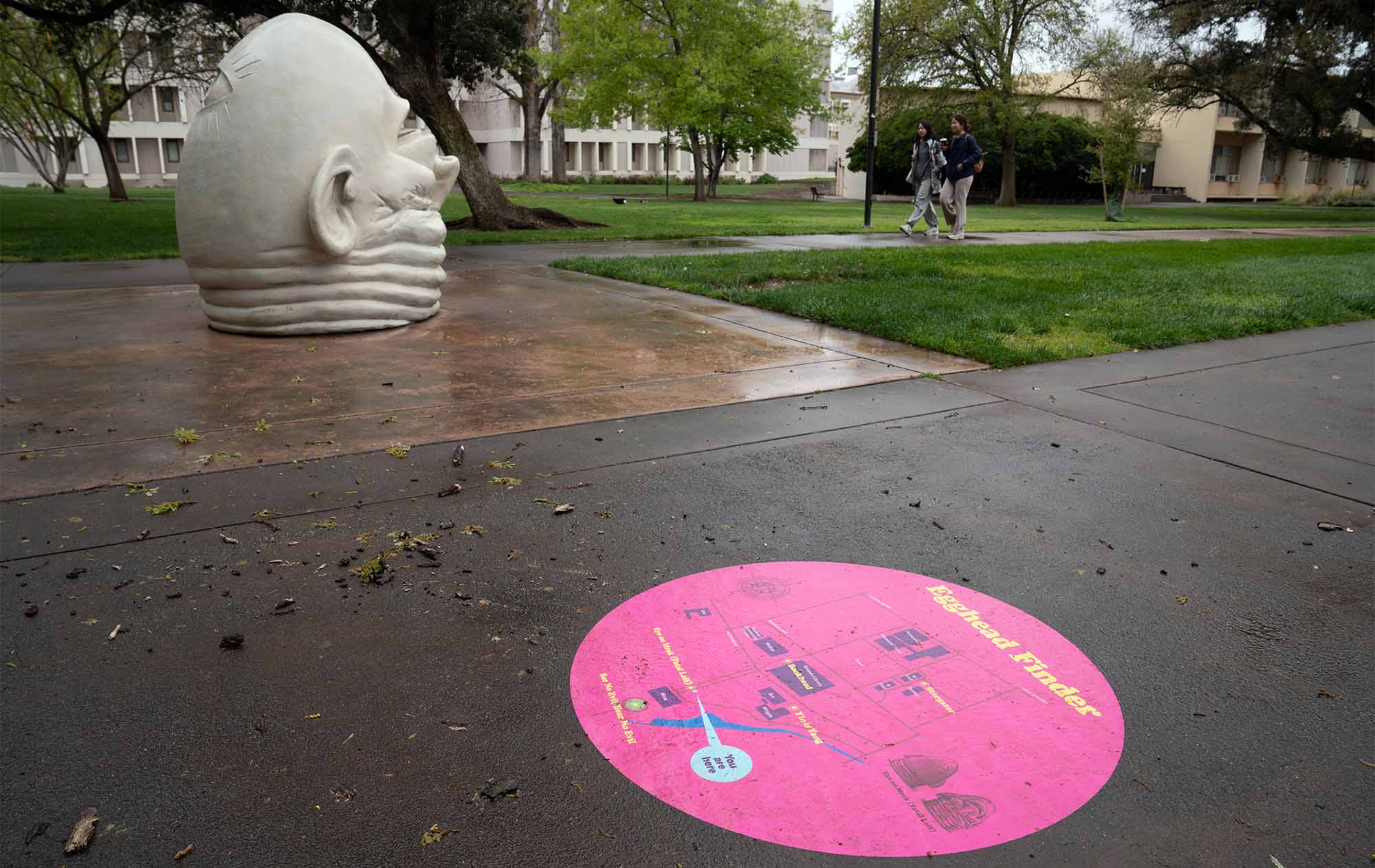 An egghead positioned outside, the top of its head wrinkled; a map of egghead locations in a pink circle in the foreground