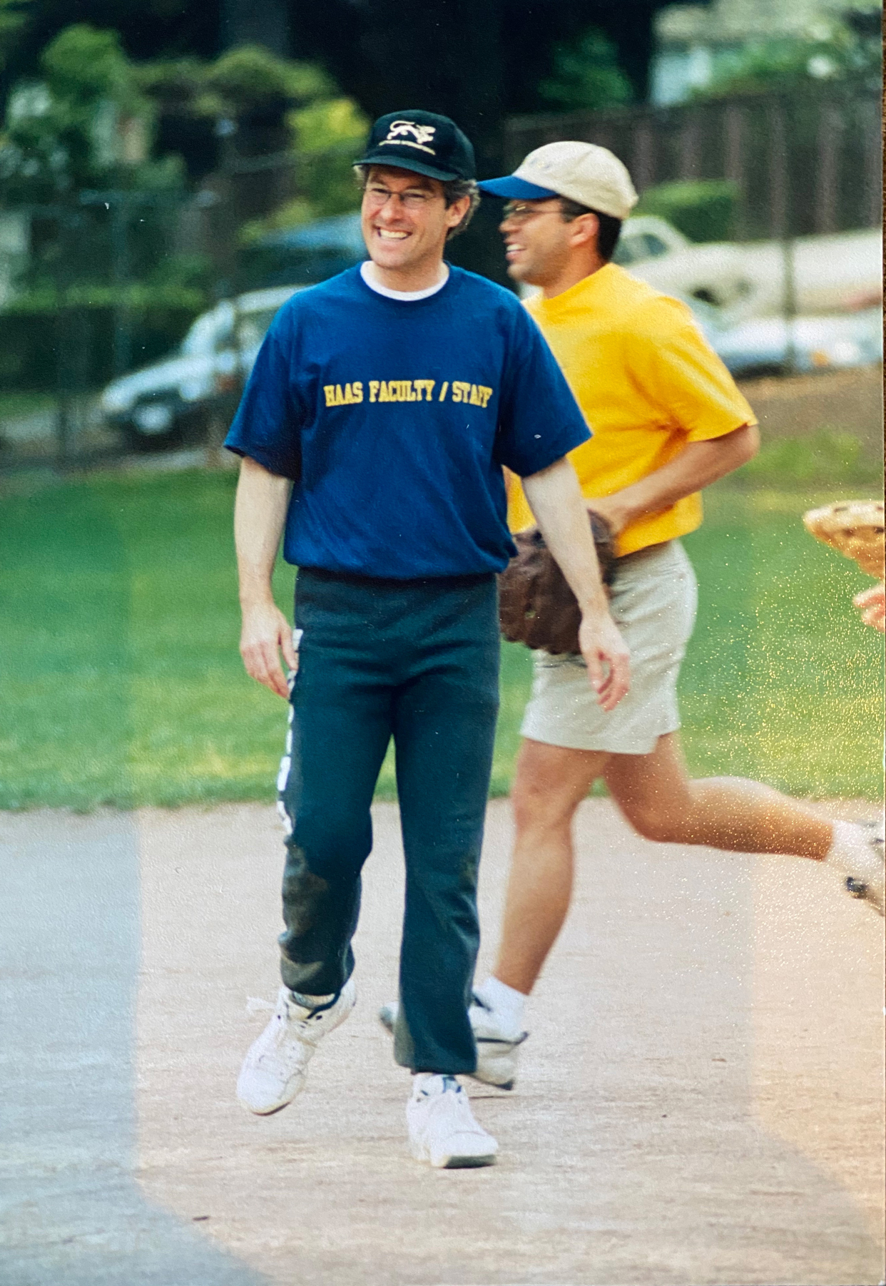 Two men on a softball field in a photo from the 90s