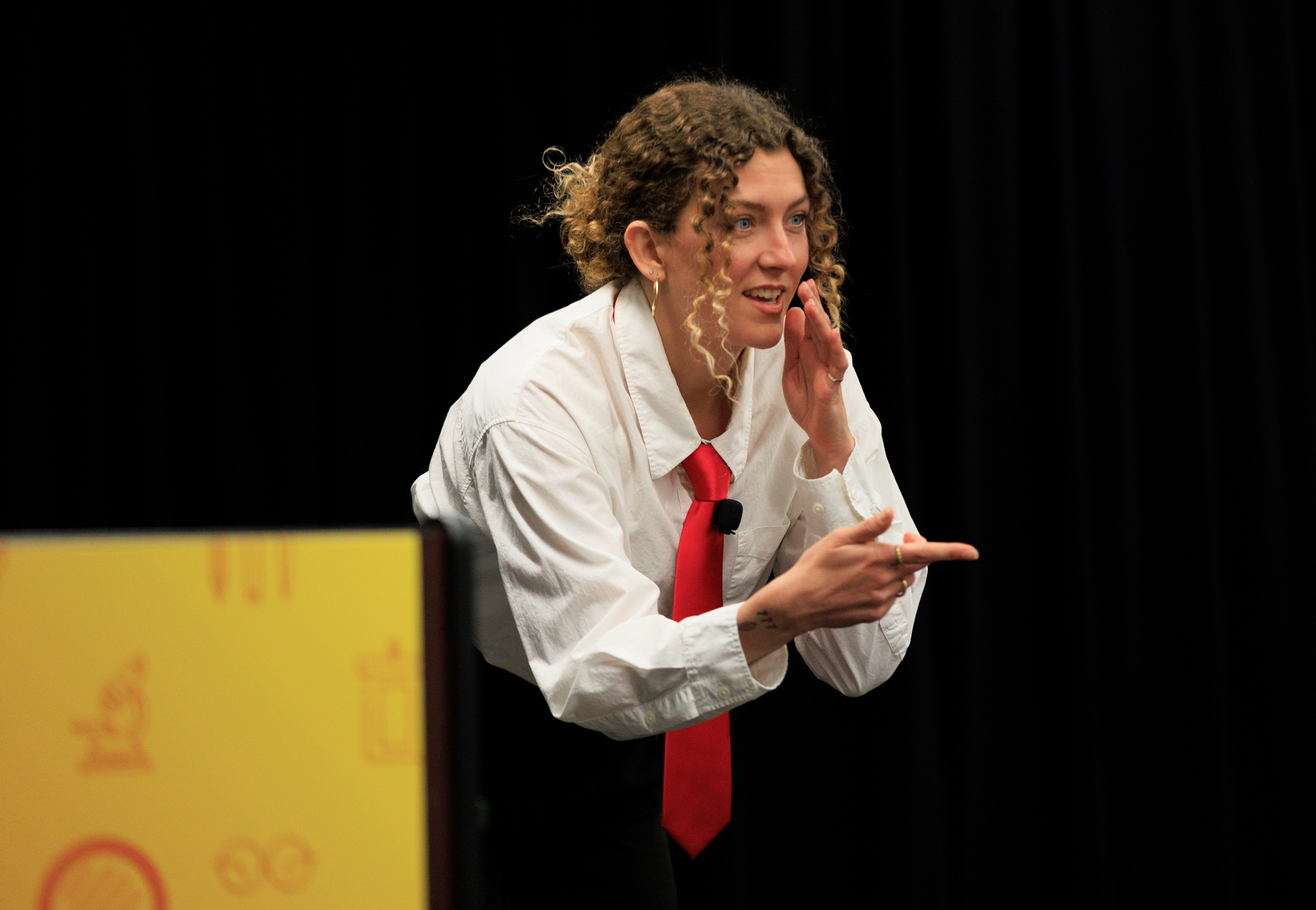 A competitor explaining something gestures with their hands at Grad Slam