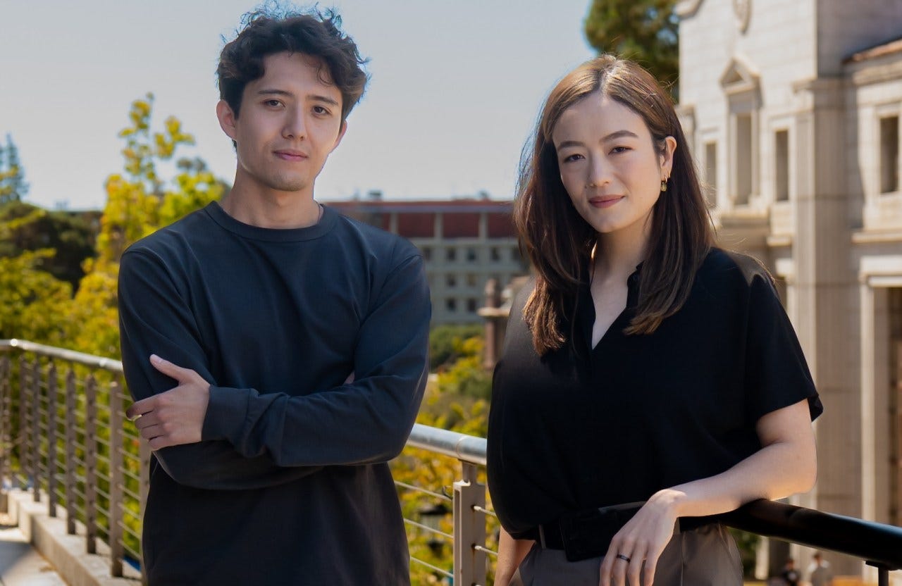 A young man and a young woman pose for a picture