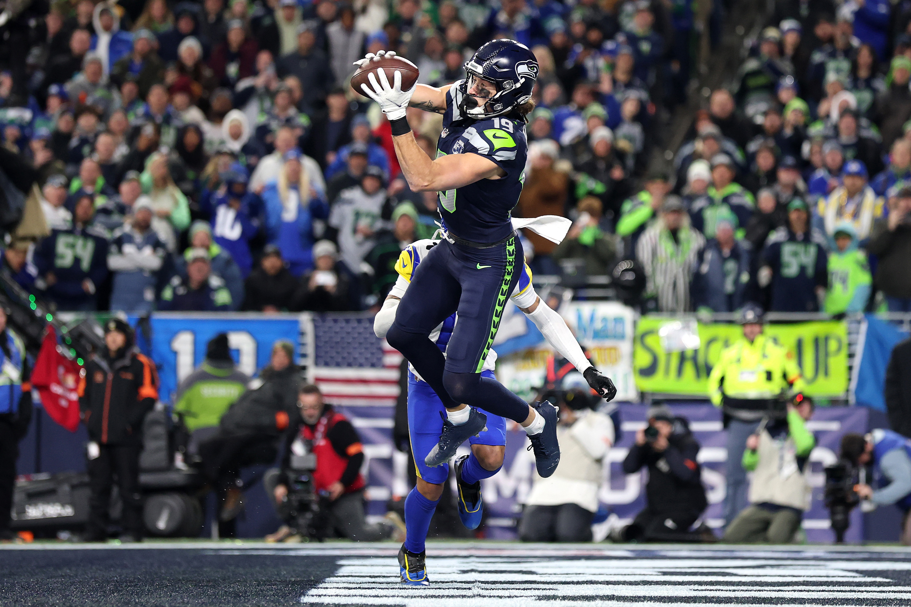 A Seattle Seahawks player jumps and catches the ball in the endzone