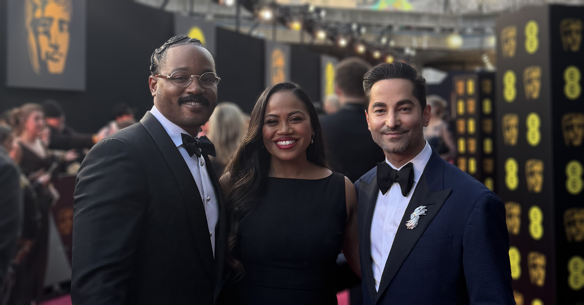 3 people in formal wear on the red carpet
