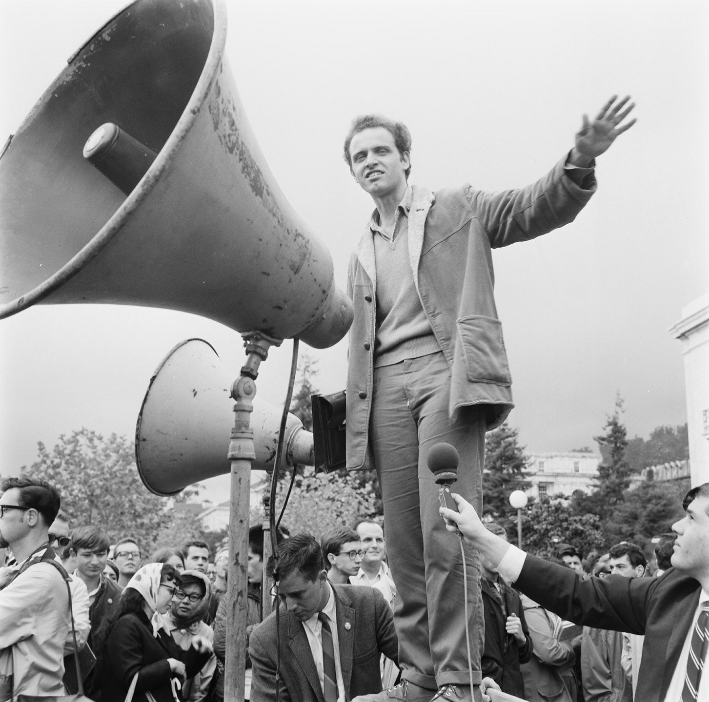 Mario Savio behind a giant megaphone at a rally
