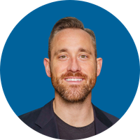 A man with a beard smiles