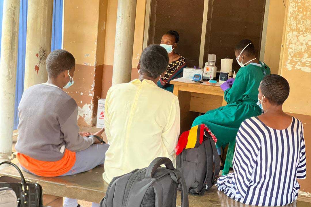 Patients in Uganda wait to take a faster tuberculosis test at a clinic.
