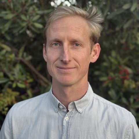 A man with light hair in a dress shirt