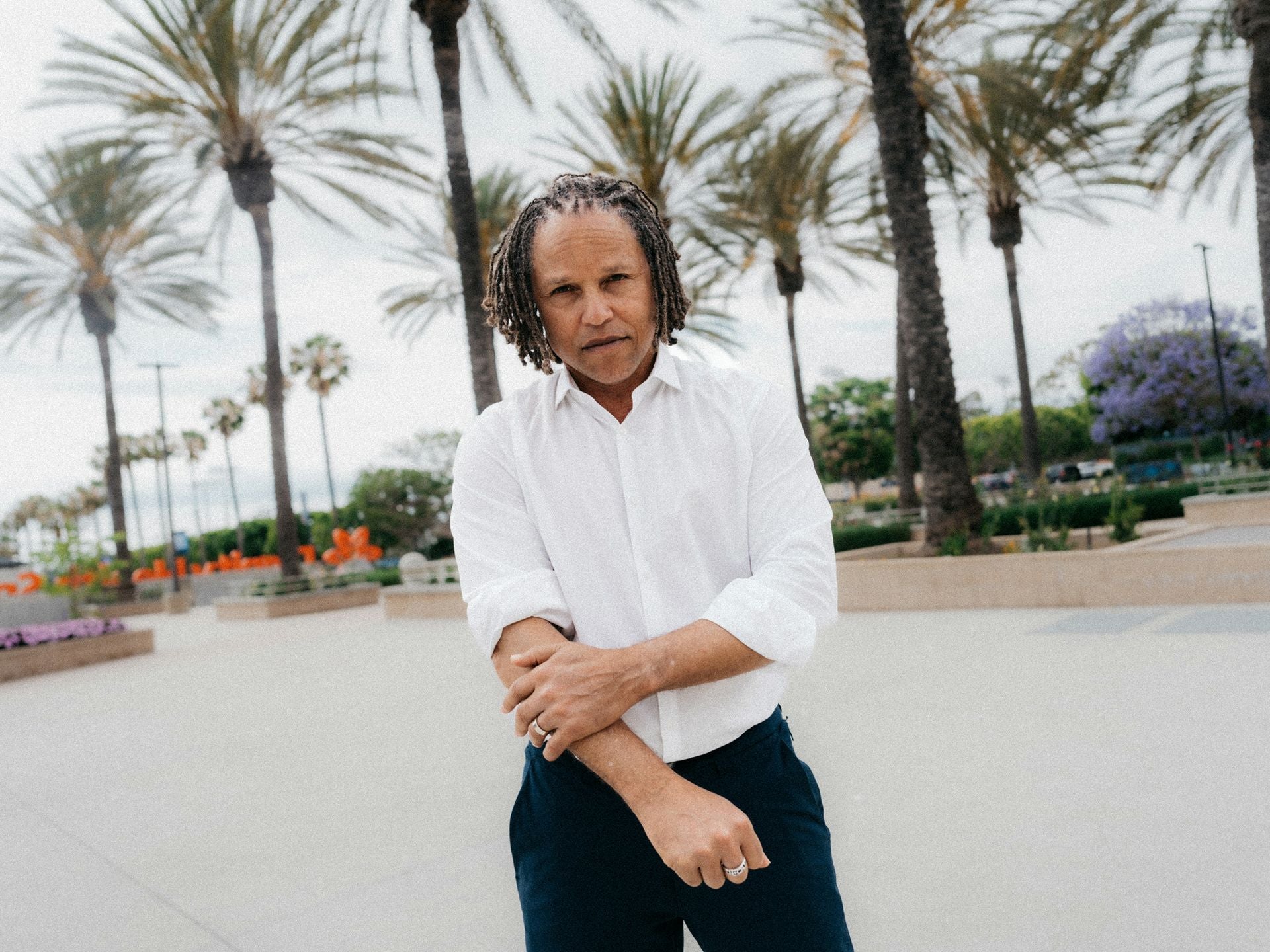 Cobi Jones, man with locs, stands on the UCLA campus