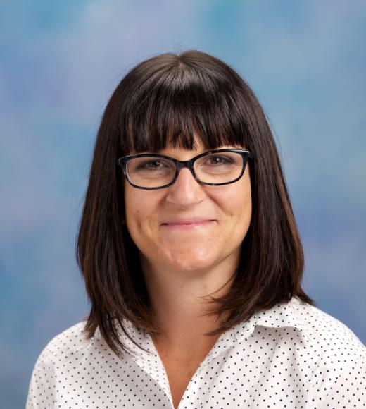 A woman with glasses headshot