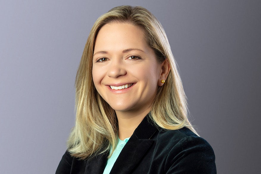Woman with shoulder-length blonde hair smiling
