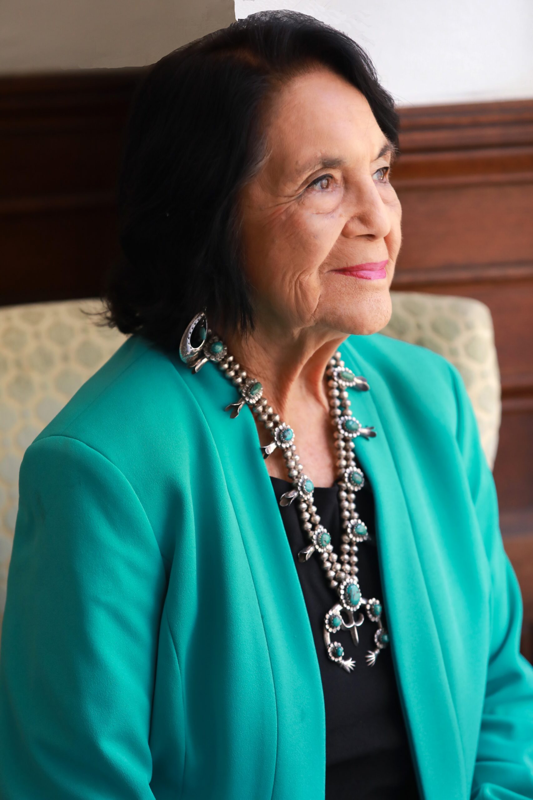 Dolores Huerta headshot in a turquoise blazer
