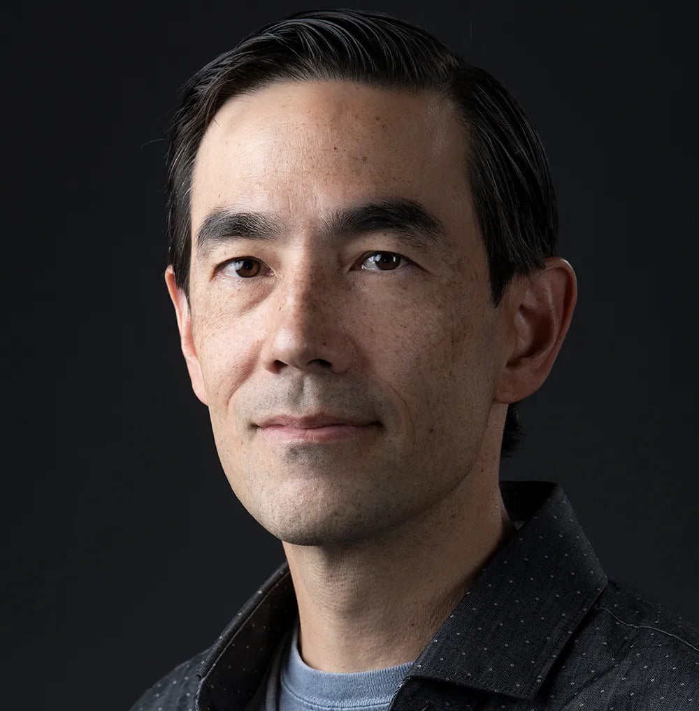 A man smiling in a headshot