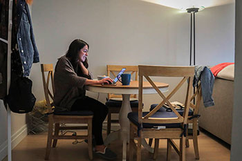 Woman works on a laptop at home