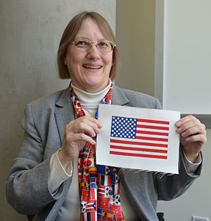 Annie Platoff holds a fireproof silica fiber beta cloth American flag patch for an Apollo-era spacesuit