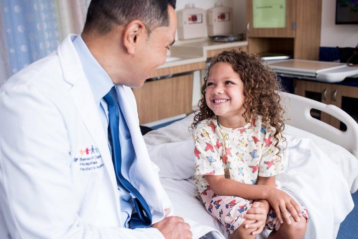 Kurtis Auguste, MD, a pediatric neurosurgeon, talks with a child in the Pediatric Brain Center at the UCSF Benioff Children’s Hospital. Kurtis Auguste, MD, a pediatric neurosurgeon, talks with a child in the Pediatric Brain Center at the UCSF Benioff Children’s Hospital.
