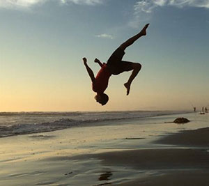 Tyler doing a flip on the beach