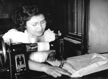 A girl in a sewing class uses an electric sewing machine