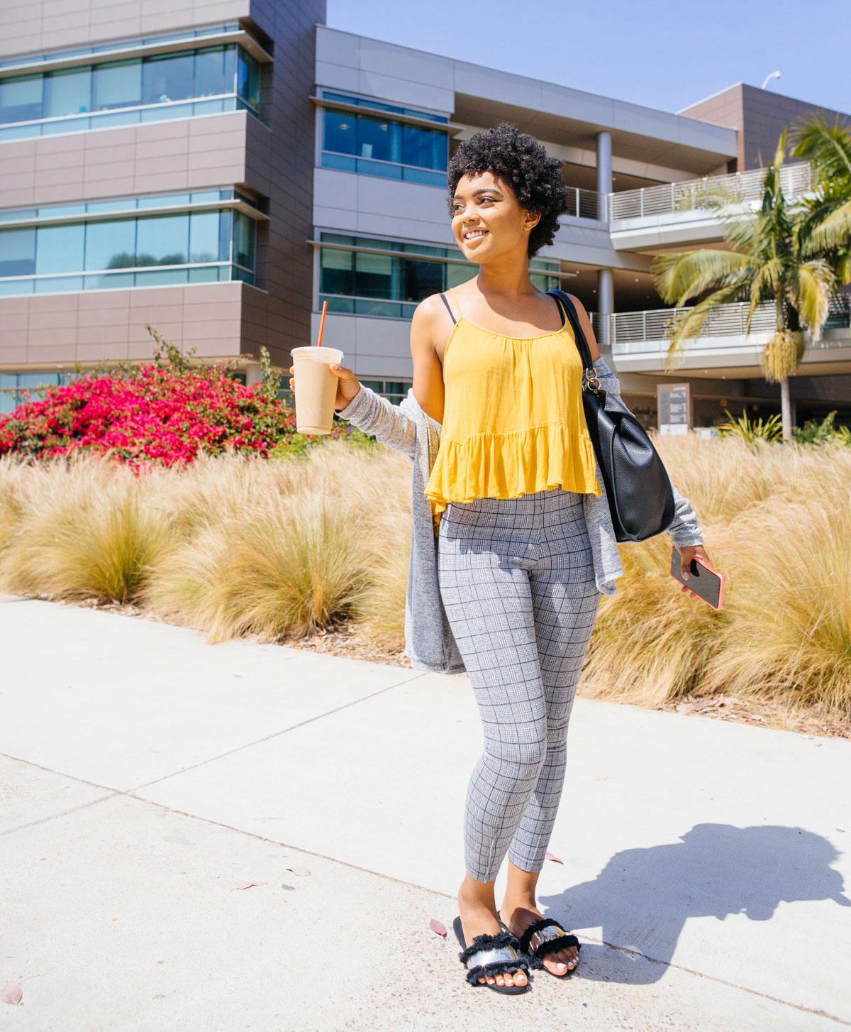 Female student in yellow top poses for picture