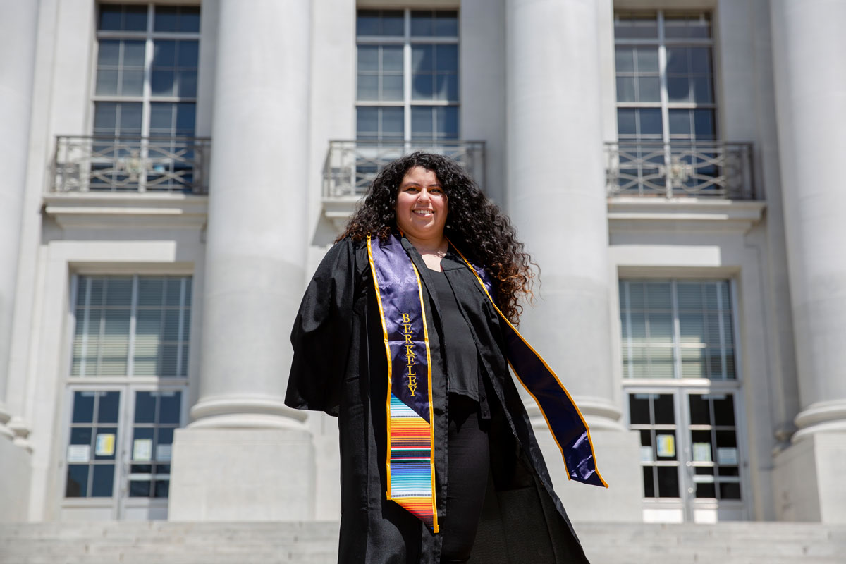 Aurora Lopez in cap and gown in front of Sproul at UC Berkeley