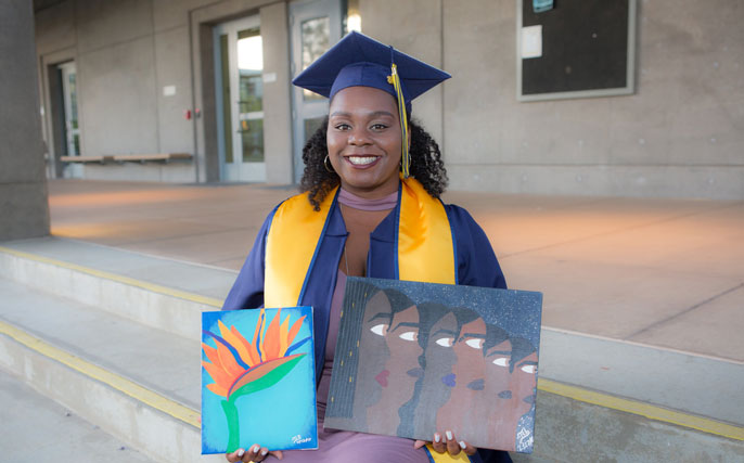 Banks holds two paintings in tribute to her late mother