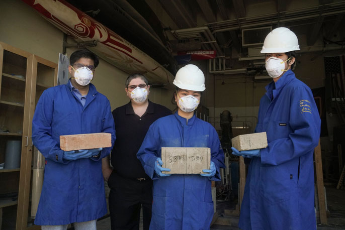 Four researchers, three holding blocks