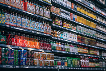 A grocery store shelf of soft drinks