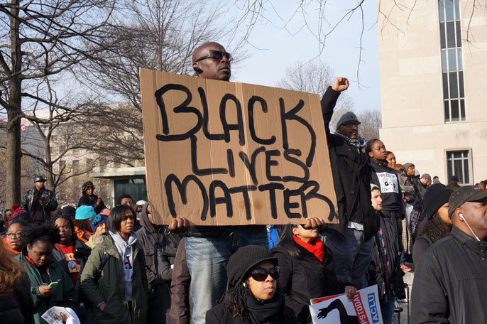 Black Lives Matter protest; man holding Black Lives Matter sign