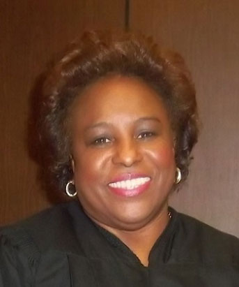 Brenda Harbin-Forte smiling with a black robe on