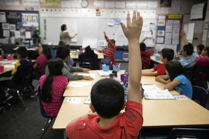 Boy raises hand in classroom Los Angeles Times photo