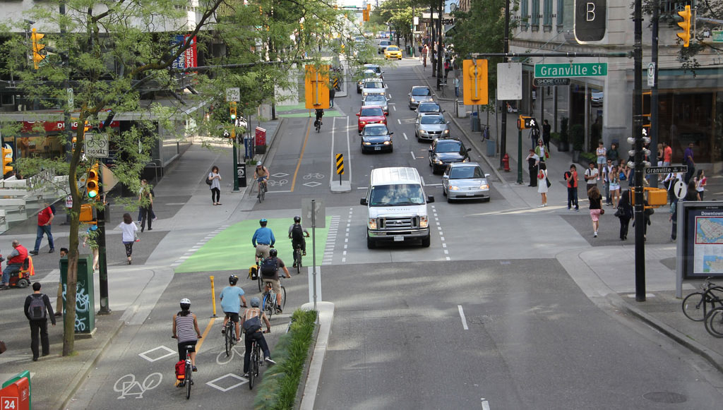 a street with a bike lane and safer sidewalks