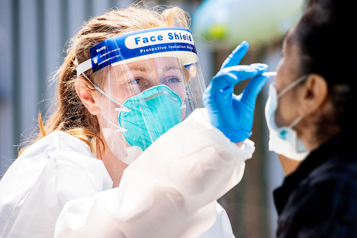 Woman administers a COVID-19 swab