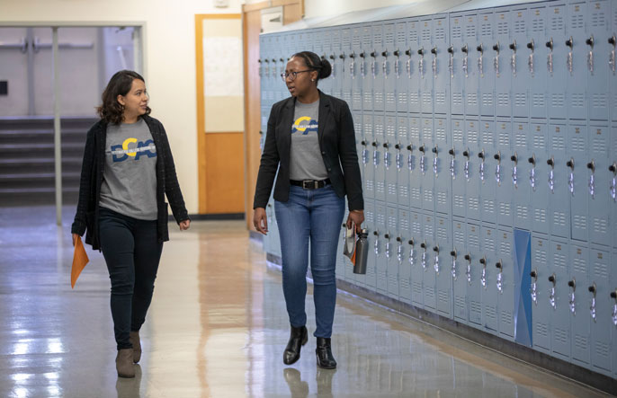 Thalia Rodriguez and Jennifer Ferguson walking down a hallway together