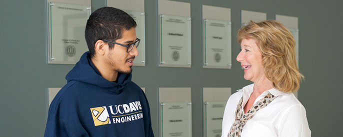 Dean Jennifer Sinclair Curtis, right, talking with a male student