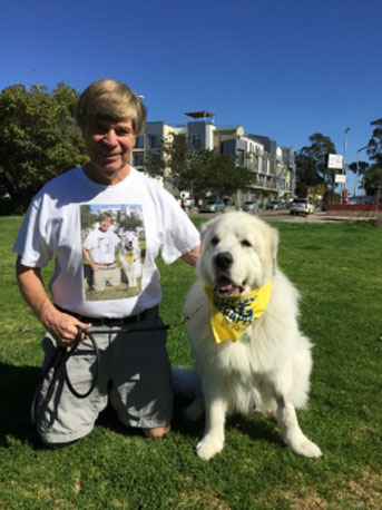 Tommy Dickey with one of his Great Pyrenees therapy dogs
