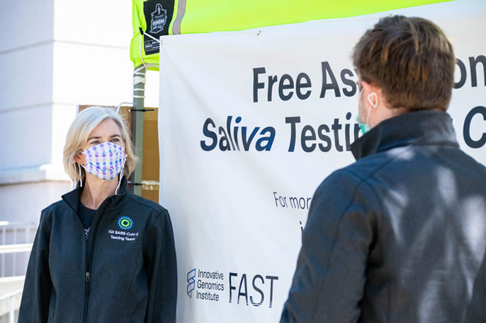 Jennifer Doudna, wearing mask, outside kiosk