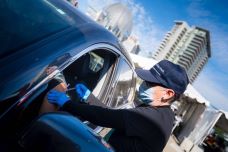 Carrie L. Byington, M.D., University of California Health executive vice president and an infectious disease expert, administering COVID-19 vaccinations to a person in a car at the Petco Park site this spring.