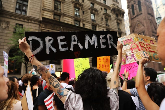 Dreamer supporters holding up signs at a rally
