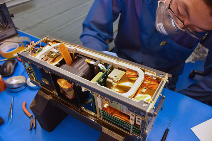 Ethan Tsai works on the flight model assembly for the CubeSat ELFIN.