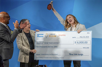 Katie Murphy with her Grad Slam-winning check and the Slammy celebrates next to former UC President Janet Napolitano