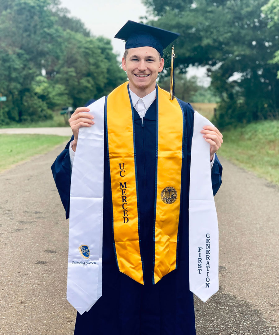 Michael Grey in cap and gown outside