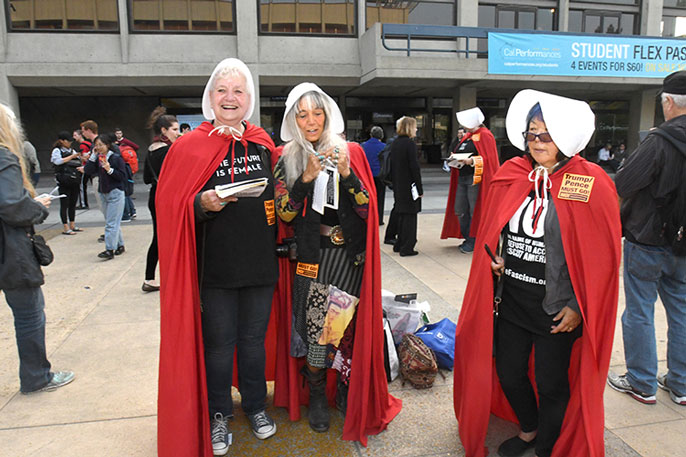 Women dressed like handmaids