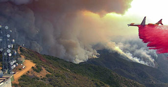 A plane tries to put out the Holy Fire with UC San Diego fire-spotting cameras nearby