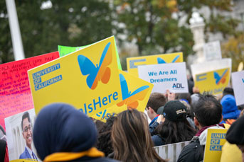 Home is Here signs in the crowd