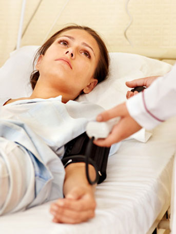 Young woman lying in hospital bed