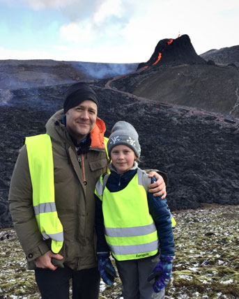 Matthew Jackson and daughter in front of active volcano in Iceland